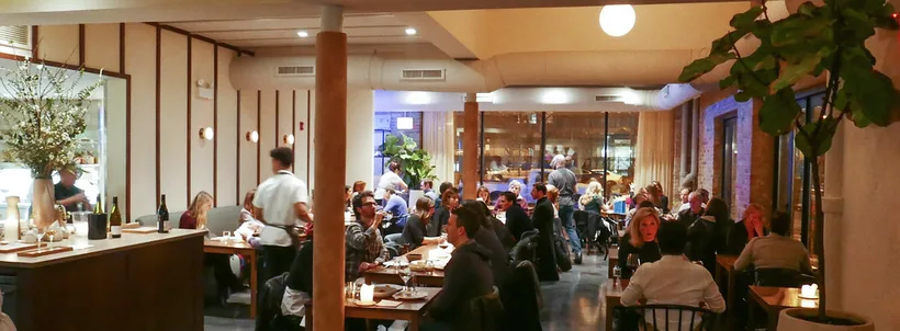 Elske dining room in March 2017, with diners and wood paneling