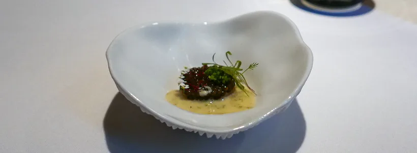 Caviar and cured hamachi at Oriole in May 2018, in a pale ceramic bowl