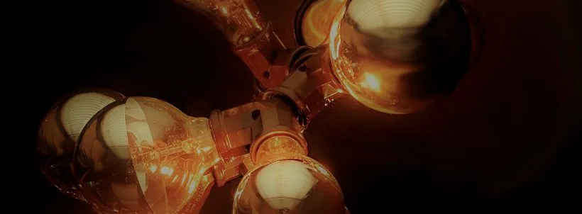 Cluster of glowing exposed light bulbs