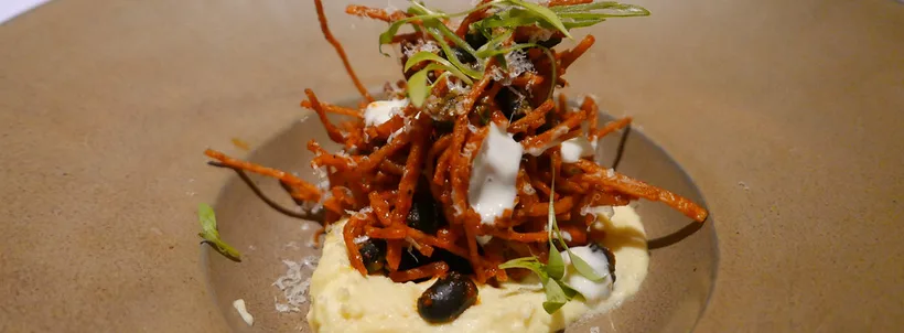 Guajillo chilaquiles at Topolobampo in May 2018, with cheese and cream